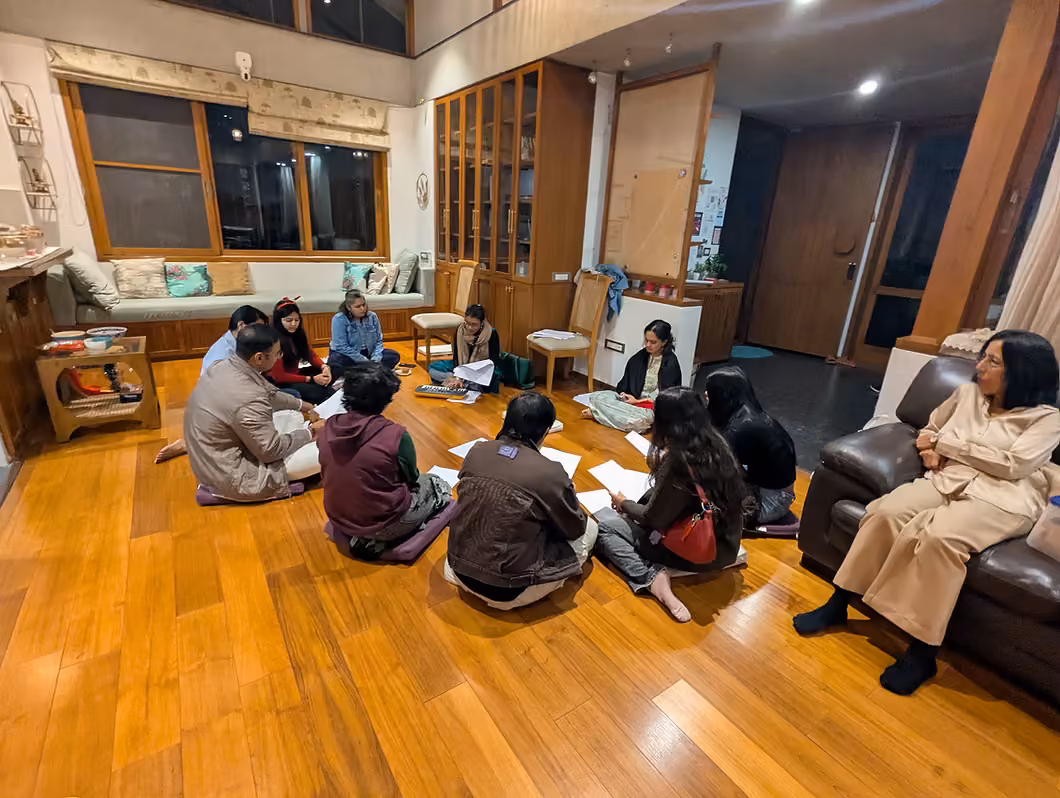 A circle of people sitting on the floor at Sanctuary on opening night